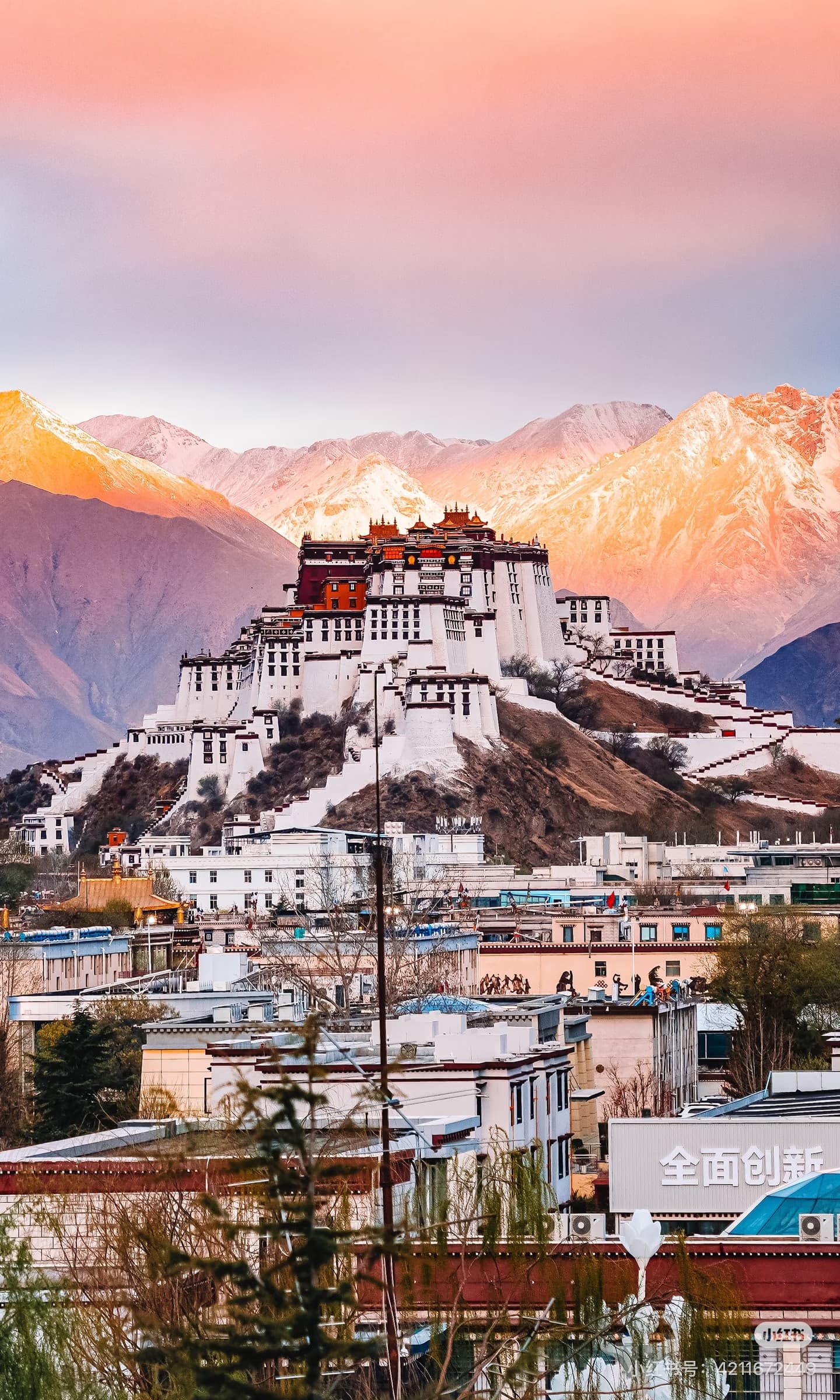 Panoramic view of Potala Palace, Lhasa, Tibet, bathed in a vibrant sunset with majestic mountains - ChinaTripTop.