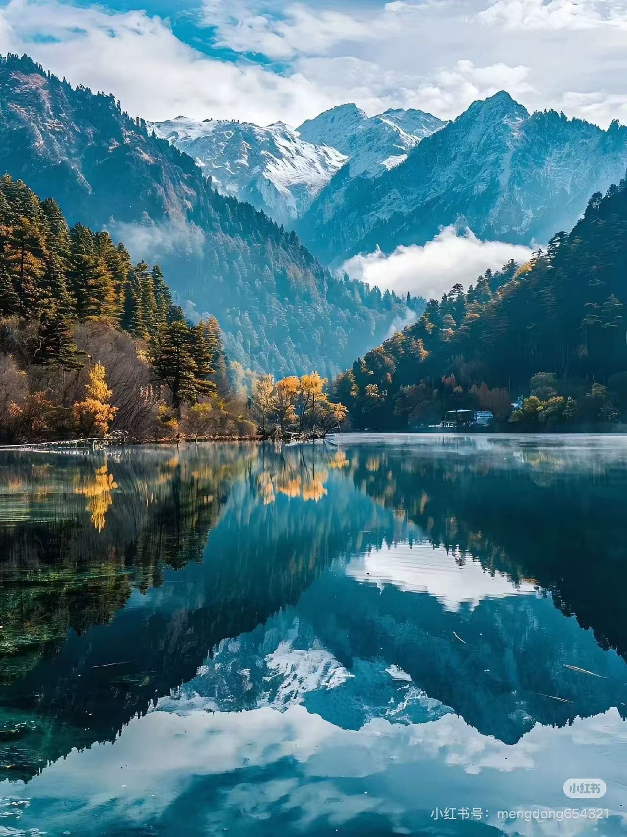 Vibrant autumn foliage and majestic snowy peaks mirrored in a tranquil mountain lake, Jiuzhaigou, China - ChinaTripTop.